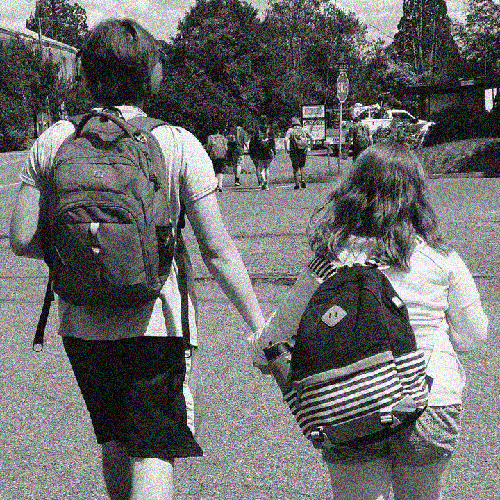 Two ACAP campers walking hand-in-hand.