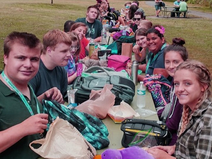 A group of ACAP campers eating lunch at a park.
