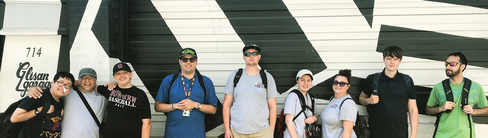 A group of ACAP mentors and staff posing in front of a mural in Portland, OR